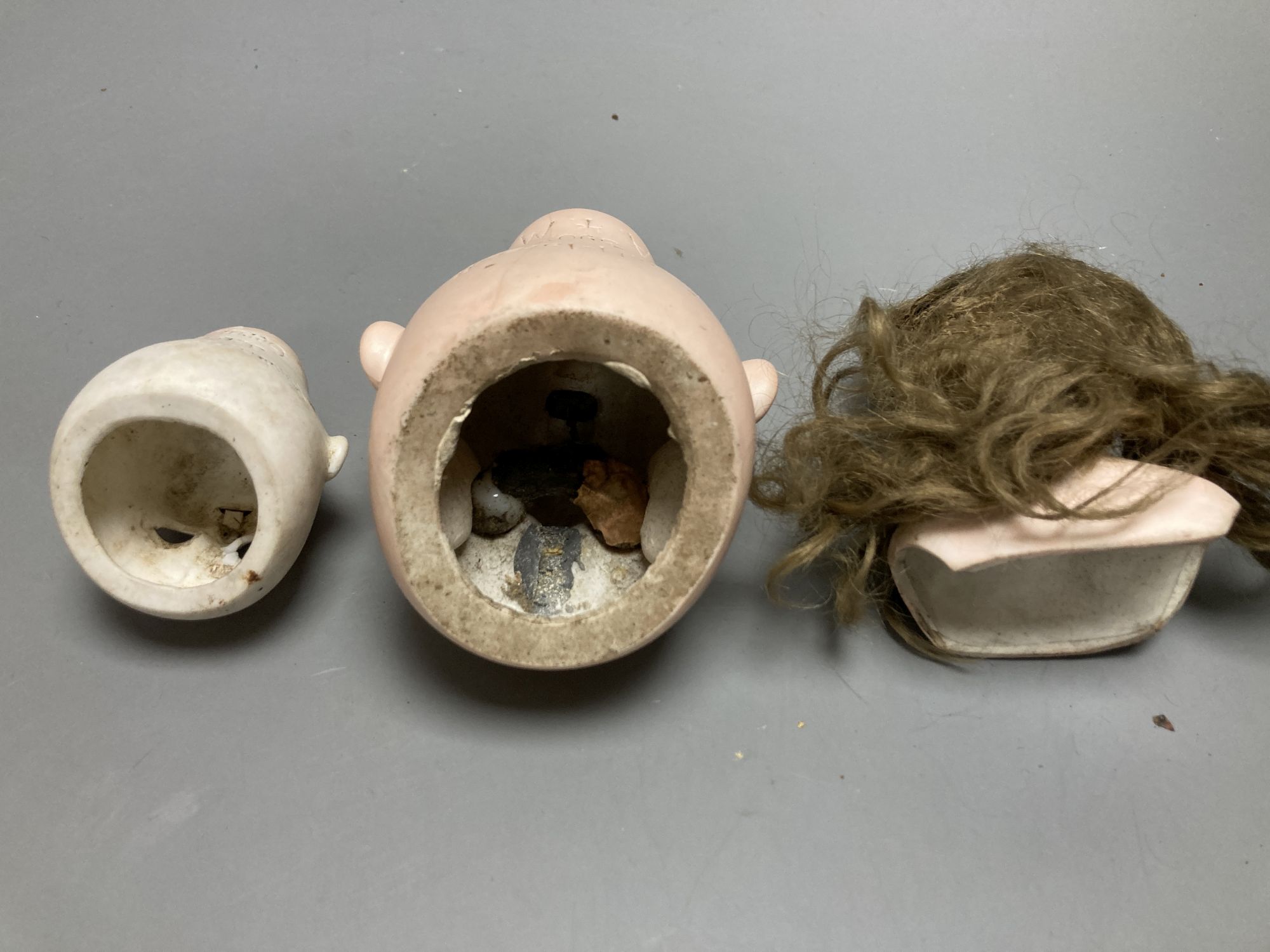 An Armand Marseille 390 bisque doll head, a Heubach Koppelsdorf bisque doll head and other